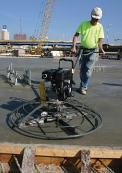 Putting on the finishing touches with a power trowel Putting on the finishing touches with a power trowel