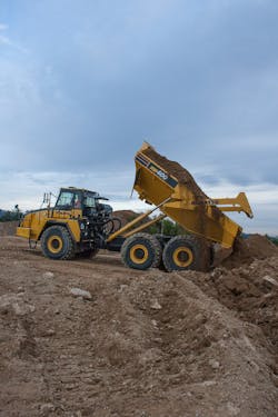 A Komatsu HM400 dumps its load. A Komatsu HM400 dumps its load.