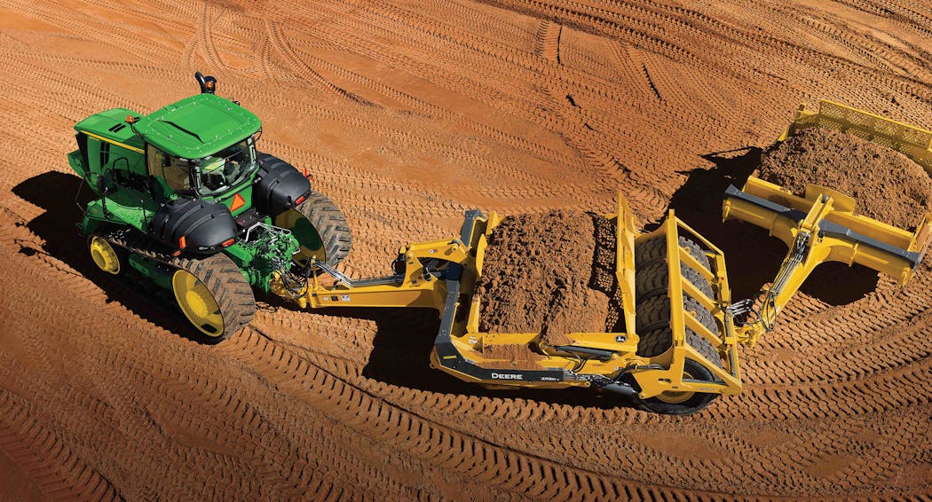 A John Deere scraper system featuring a 9570RT track tractor and 2112D scraper